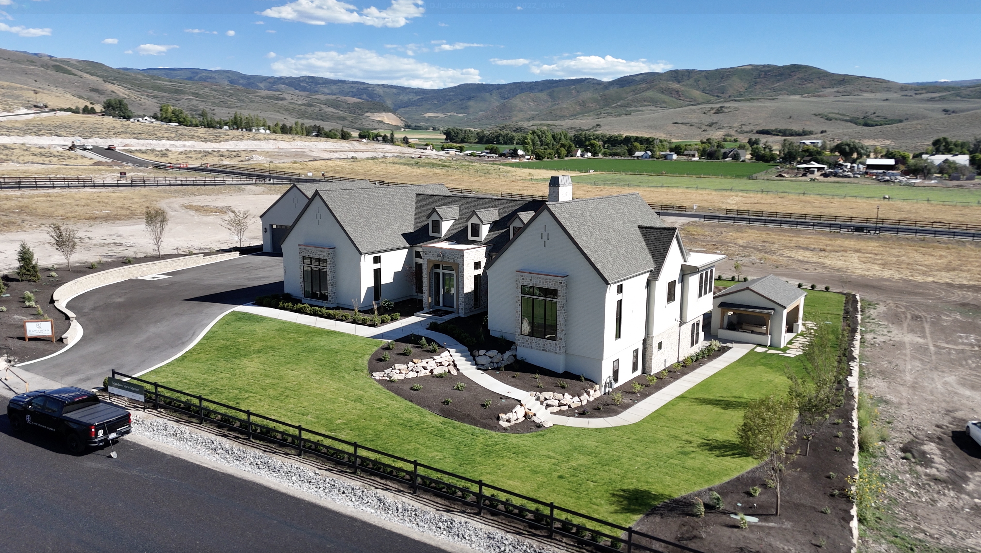 Aerial drone photography of Hawthorne custom home in Alpine, Utah with mountain backdrop